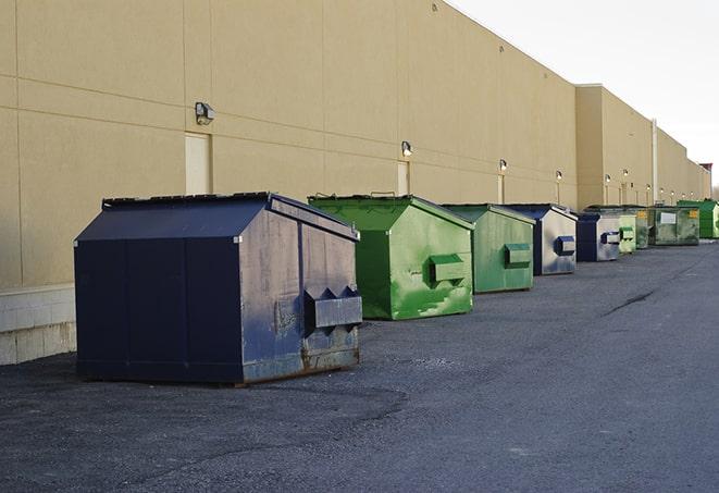 a row of blue construction dumpsters on a job site in Carbondale